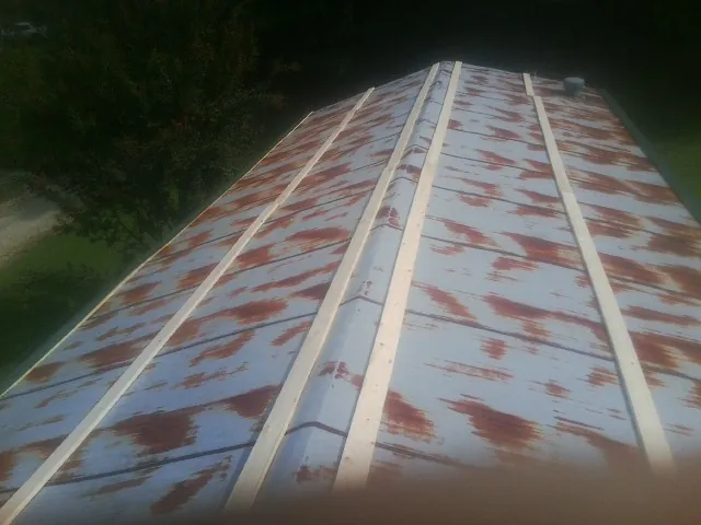 Rusted metal roof panels with new wood purlins before replacement — Storm Damage Roof Repair in Woolford by Roofing Brothers