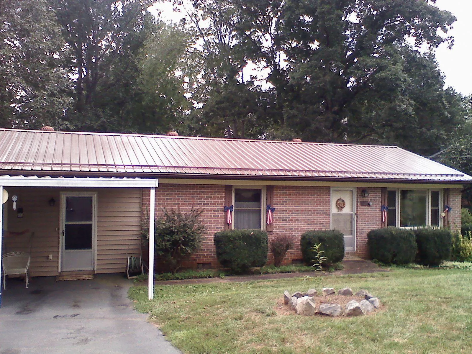Bronze metal roof and carport on a brick ranch home — Roof Repair work by our crew in Woolford